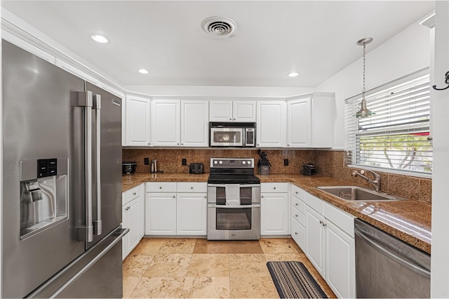 1309 Nokomis Ave S, Venice, FL 34285 - kitchen featuring appliances with stainless steel finishes, decorative backsplash, white cabinetry, and recessed lighting