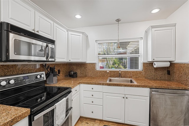 1309 Nokomis Ave S, Venice, FL 34285 - kitchen featuring appliances with stainless steel finishes, white cabinetry, pendant lighting, tasteful backsplash, and recessed lighting