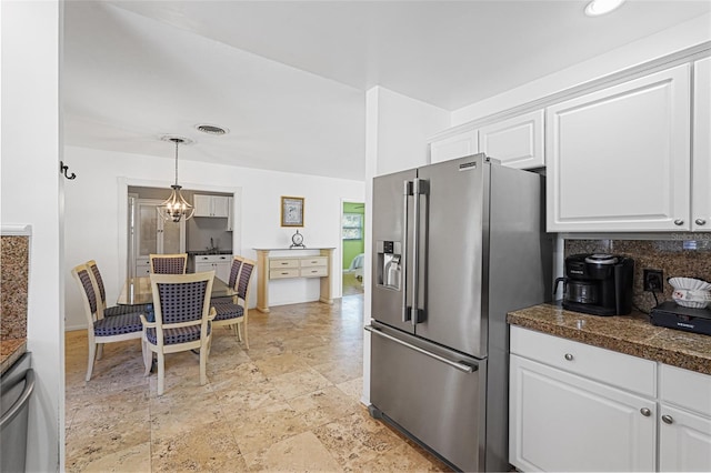 1309 Nokomis Ave S, Venice, FL 34285 - kitchen featuring stainless steel fridge with ice dispenser, tile counters, white cabinetry, decorative backsplash, and decorative light fixtures