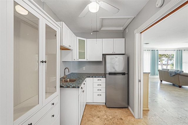 1309 Nokomis Ave S, Venice, FL 34285 - kitchen featuring freestanding refrigerator, glass insert cabinets, white cabinetry, open floor plan, and dark stone countertops