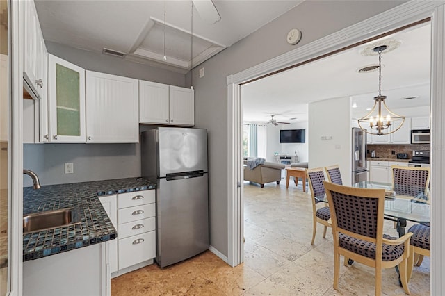 1309 Nokomis Ave S, Venice, FL 34285 - kitchen featuring stainless steel appliances, a ceiling fan, white cabinetry, and glass insert cabinets