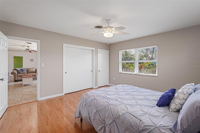 1309 Nokomis Ave S, Venice, FL 34285 - bedroom featuring light wood-type flooring, ceiling fan, and two closets
