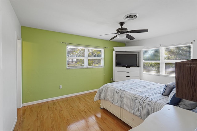 1309 Nokomis Ave S, Venice, FL 34285 - bedroom with multiple windows, wood finished floors, and ceiling fan