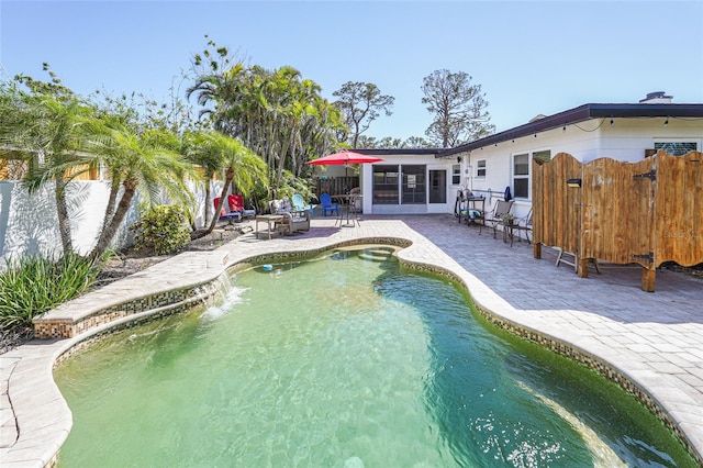 1309 Nokomis Ave S, Venice, FL 34285 - view of swimming pool with a patio, a sunroom, and a fenced backyard