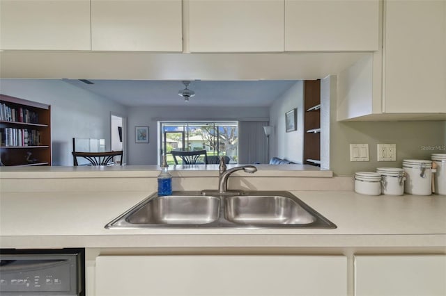 kitchen with white cabinetry, dishwashing machine, and sink