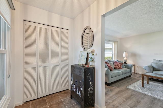 living area with hardwood / wood-style floors and a textured ceiling