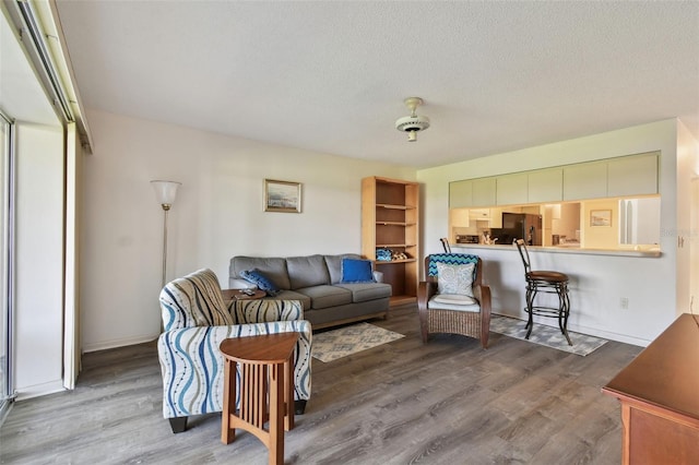 living room with hardwood / wood-style flooring and a textured ceiling