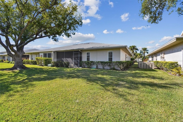 view of front of home with a sunroom and a front yard