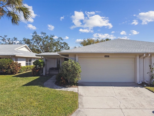 single story home featuring a garage and a front yard