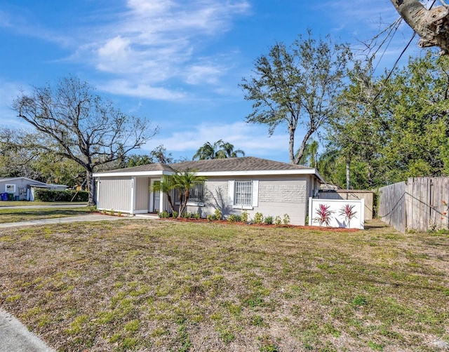 ranch-style home with a front lawn