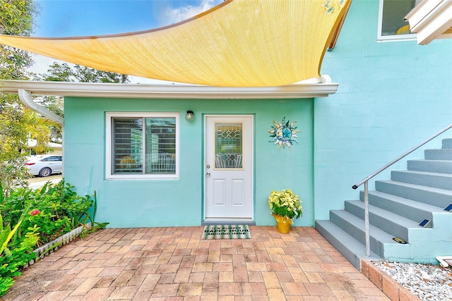 property entrance featuring a patio area