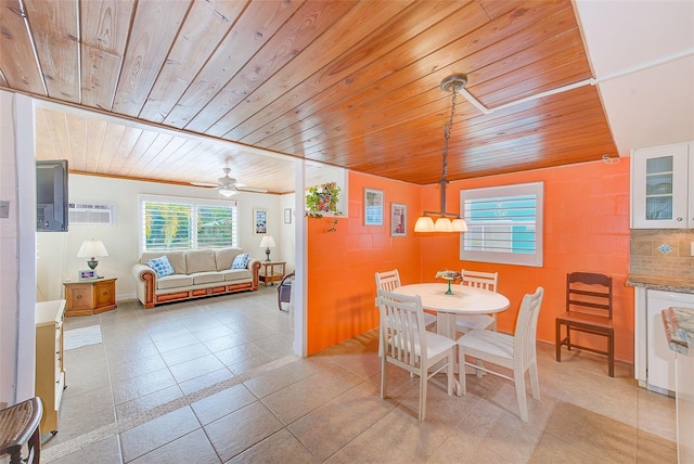 tiled dining space featuring a wall mounted AC and wooden ceiling