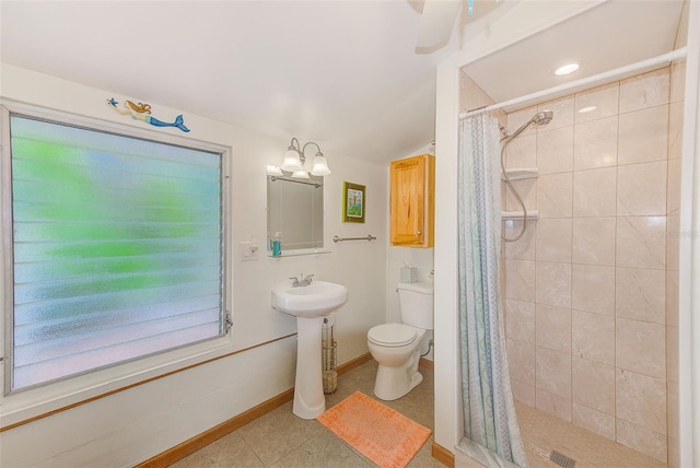 bathroom with tile patterned floors, a chandelier, toilet, and walk in shower