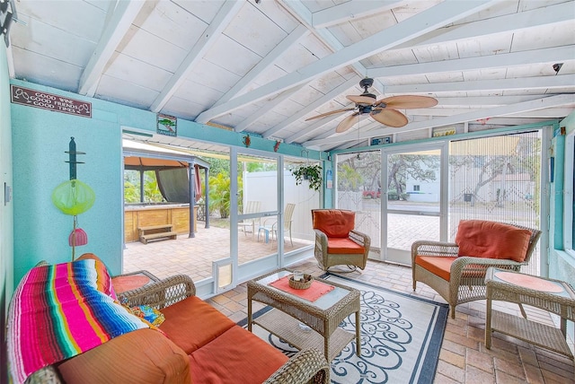 sunroom featuring lofted ceiling with beams and ceiling fan