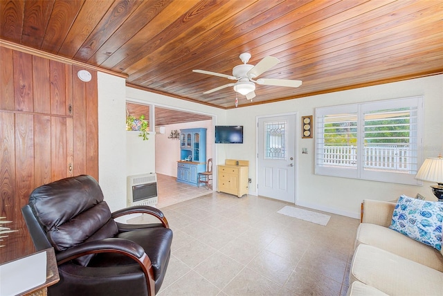 living room with heating unit, wood ceiling, ornamental molding, and ceiling fan