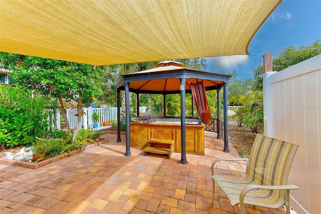 view of patio with a gazebo and a hot tub