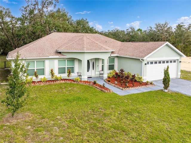 single story home featuring a garage and a front yard