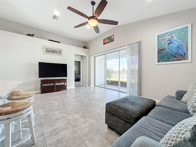 tiled living room with lofted ceiling and ceiling fan