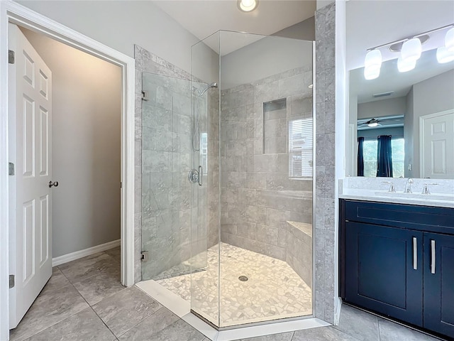 bathroom with vanity, ceiling fan, and walk in shower