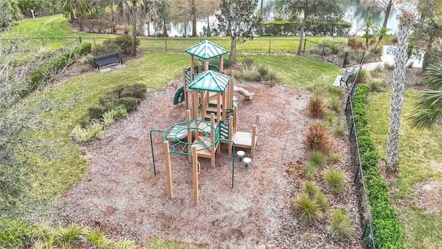 view of playground with a yard and a water view