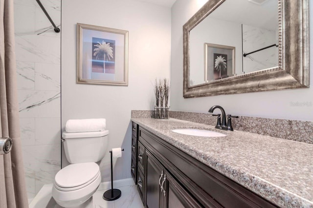 bathroom with vanity, toilet, and tiled shower