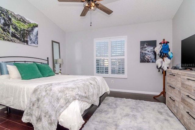 bedroom with ceiling fan and dark hardwood / wood-style floors