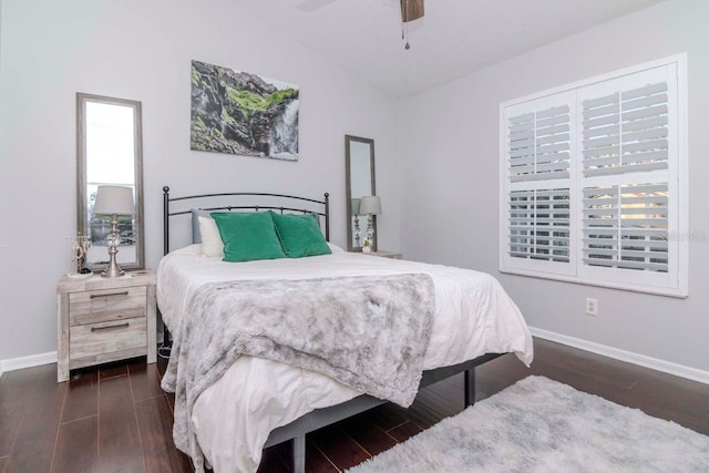 bedroom featuring vaulted ceiling, dark hardwood / wood-style floors, and ceiling fan