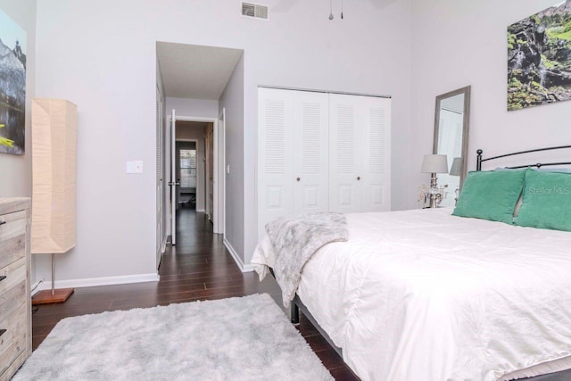 bedroom featuring dark wood-type flooring and a closet