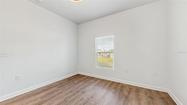 spare room with wood-type flooring