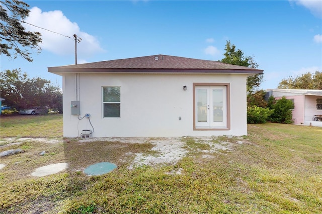 rear view of house featuring a yard