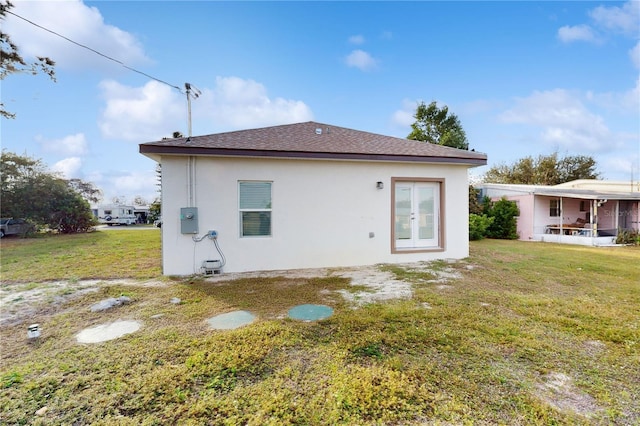 rear view of house featuring a yard