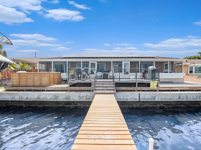 1818 Dolphin Blvd S, Saint Petersburg, FL 33707 - back of property featuring a sunroom and a water view