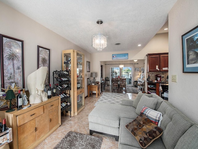 1818 Dolphin Blvd S, Saint Petersburg, FL 33707 - living room featuring an inviting chandelier, a textured ceiling, and light tile patterned flooring