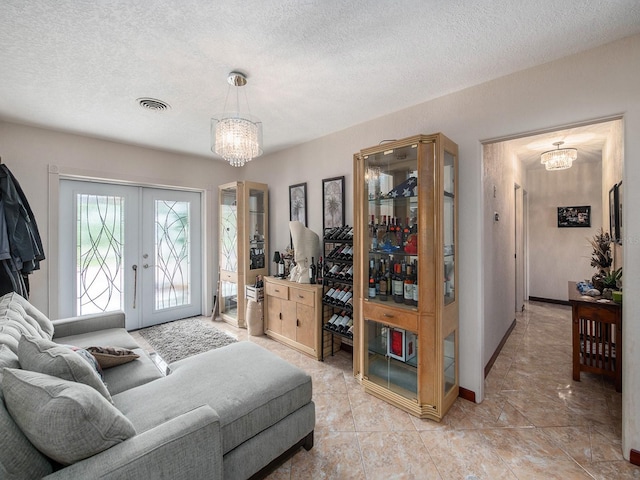 1818 Dolphin Blvd S, Saint Petersburg, FL 33707 - living room with a textured ceiling, a chandelier, and french doors