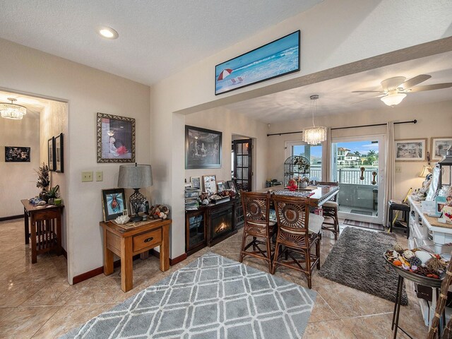 1818 Dolphin Blvd S, Saint Petersburg, FL 33707 - tiled dining space featuring ceiling fan with notable chandelier and a textured ceiling
