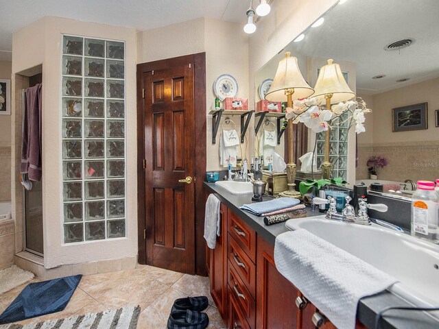 1818 Dolphin Blvd S, Saint Petersburg, FL 33707 - bathroom featuring tile patterned floors, a shower with door, and vanity