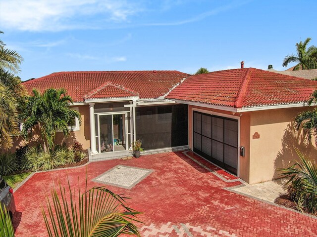 1818 Dolphin Blvd S, Saint Petersburg, FL 33707 - rear view of house featuring a garage