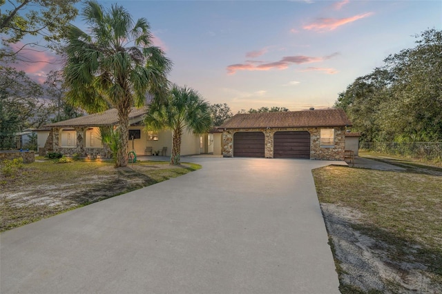 ranch-style home with a yard and a garage