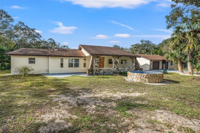 rear view of house featuring a garage, a patio, and a yard