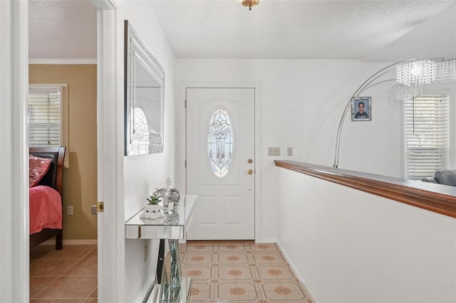 tiled entrance foyer with a textured ceiling