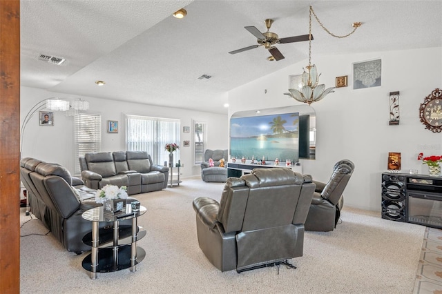 carpeted living room featuring lofted ceiling, ceiling fan, and a textured ceiling