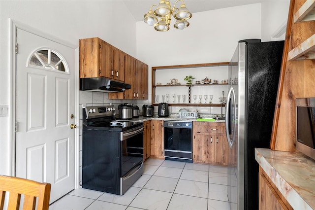 kitchen with tasteful backsplash, appliances with stainless steel finishes, and a notable chandelier