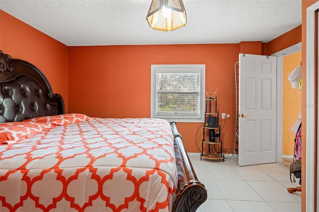 bedroom with a textured ceiling and light tile patterned flooring