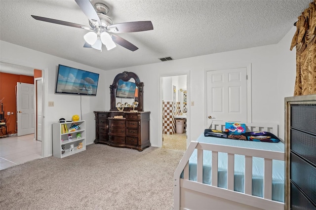 bedroom with light carpet and a textured ceiling