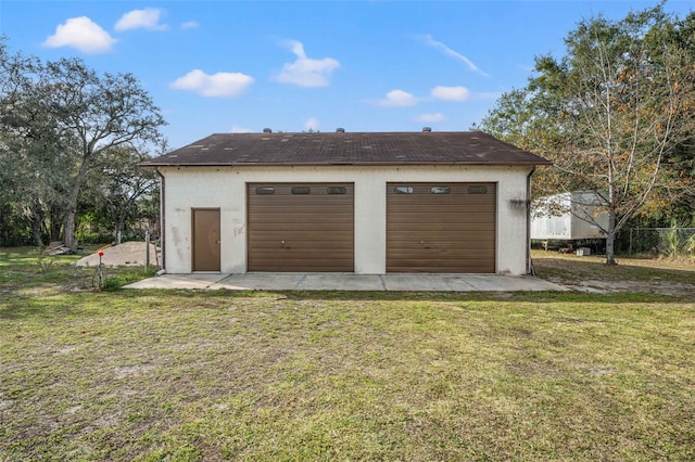 garage featuring a lawn