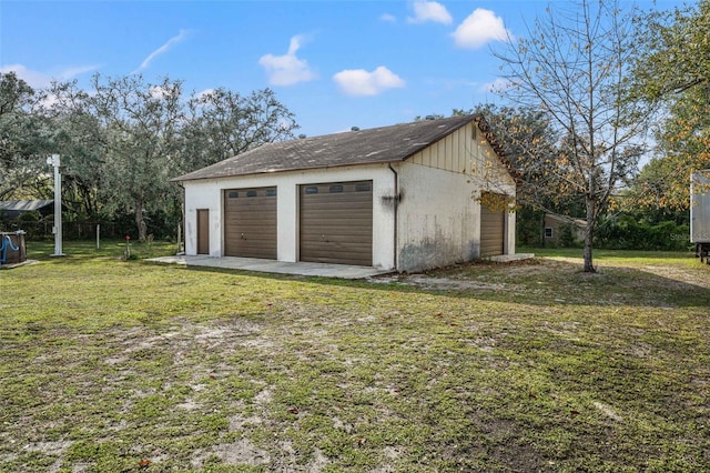 garage featuring a lawn