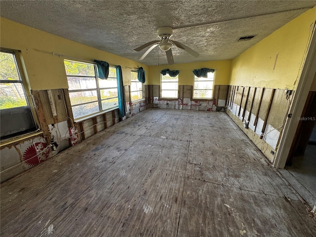 miscellaneous room featuring ceiling fan and a textured ceiling