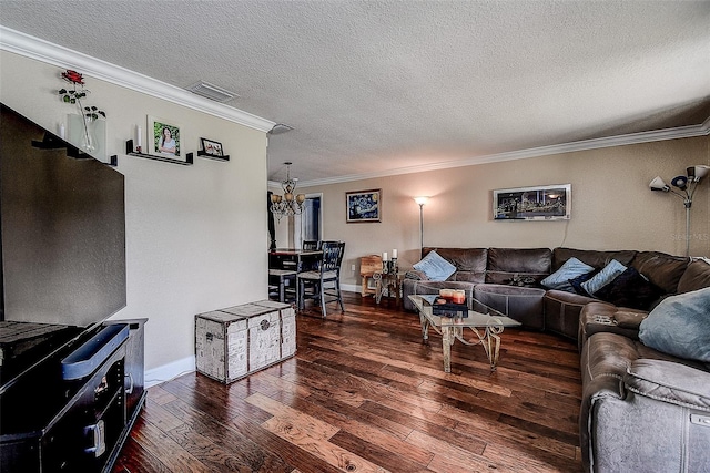 living room featuring crown molding, dark wood-type flooring, a notable chandelier, and a textured ceiling