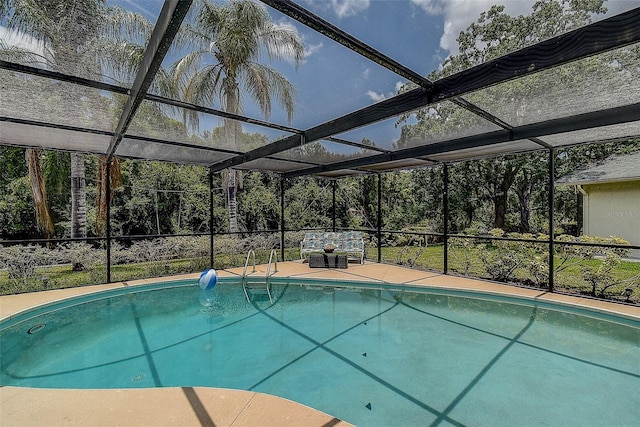 view of swimming pool with glass enclosure