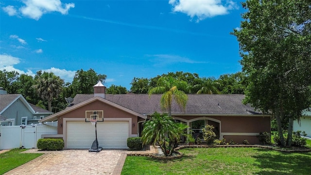 single story home with a garage and a front yard